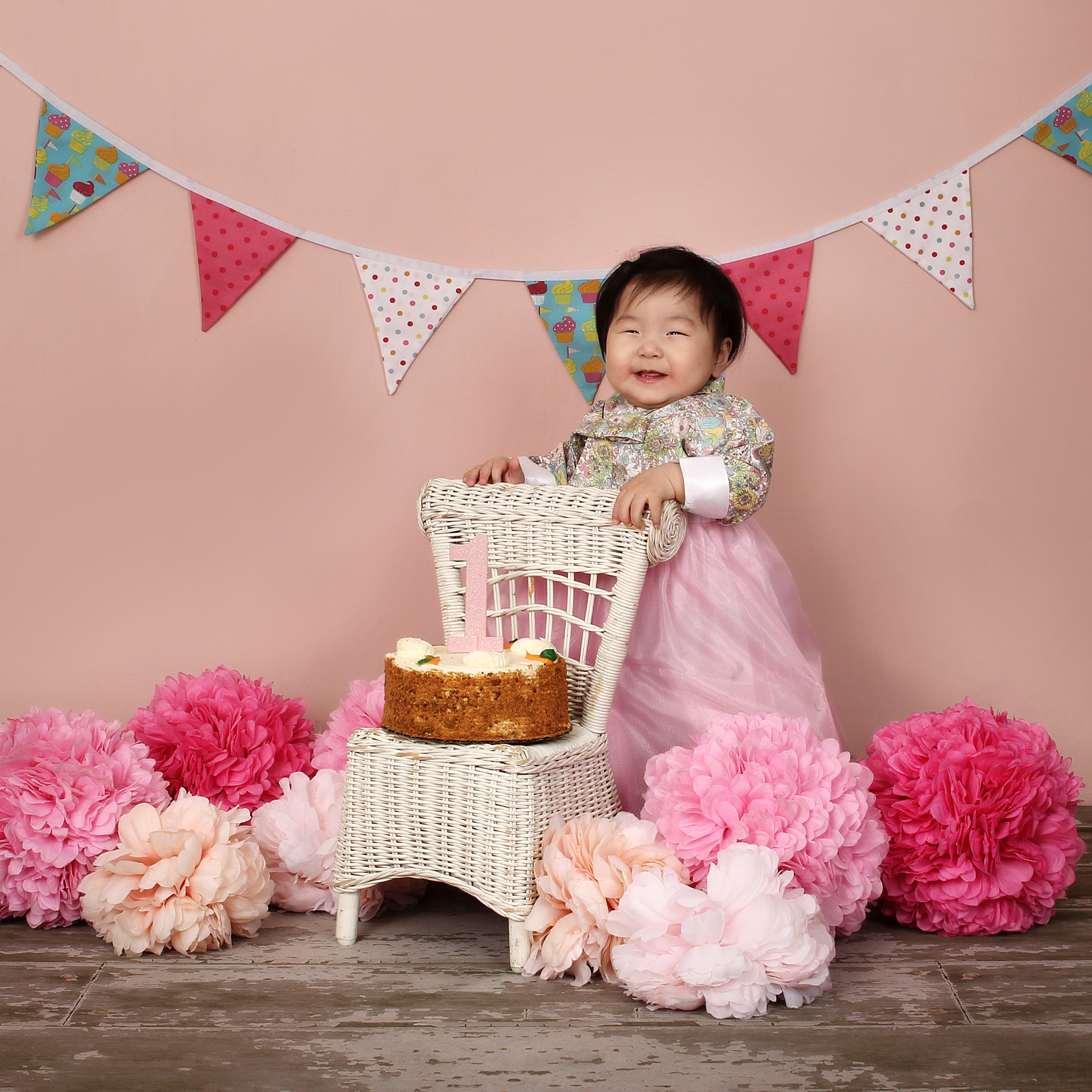 Banner & Pink Poofs w/White Wicker Chair On Pink