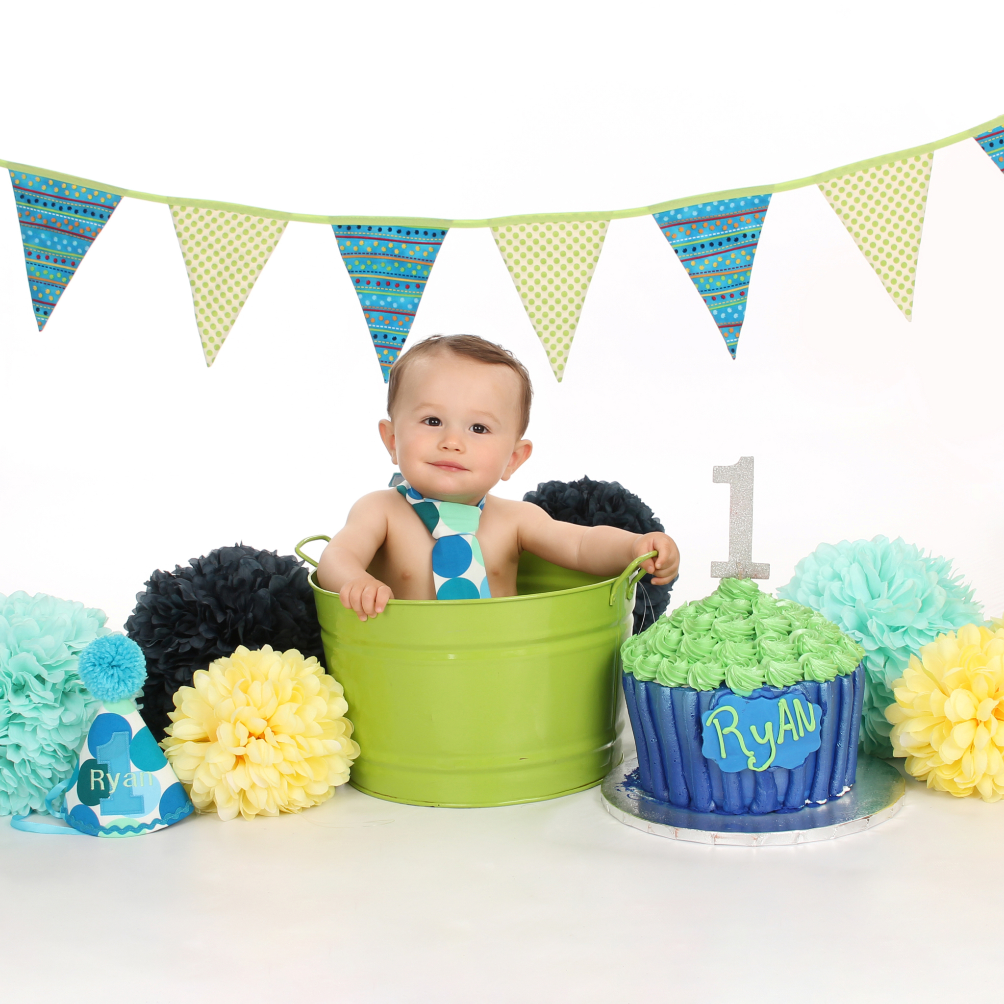 Banner w/Green, Blue & Yellow Poofs in Bucket On White